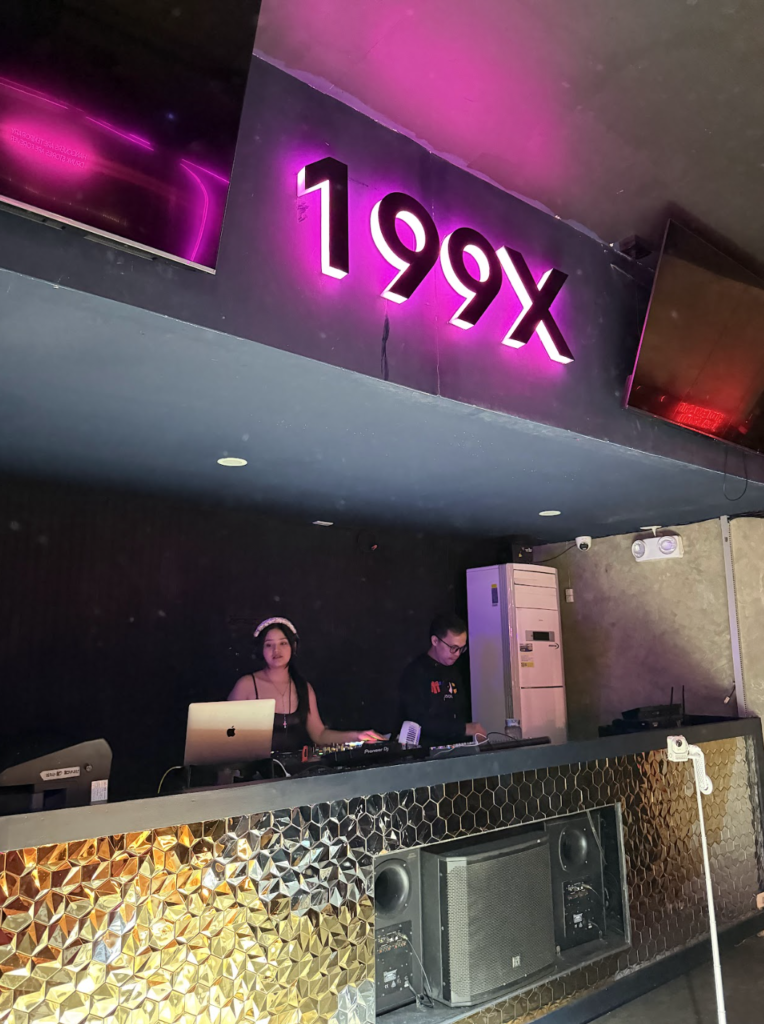 The DJ booth at 199X Club Davao featuring ambient purple neon lighting