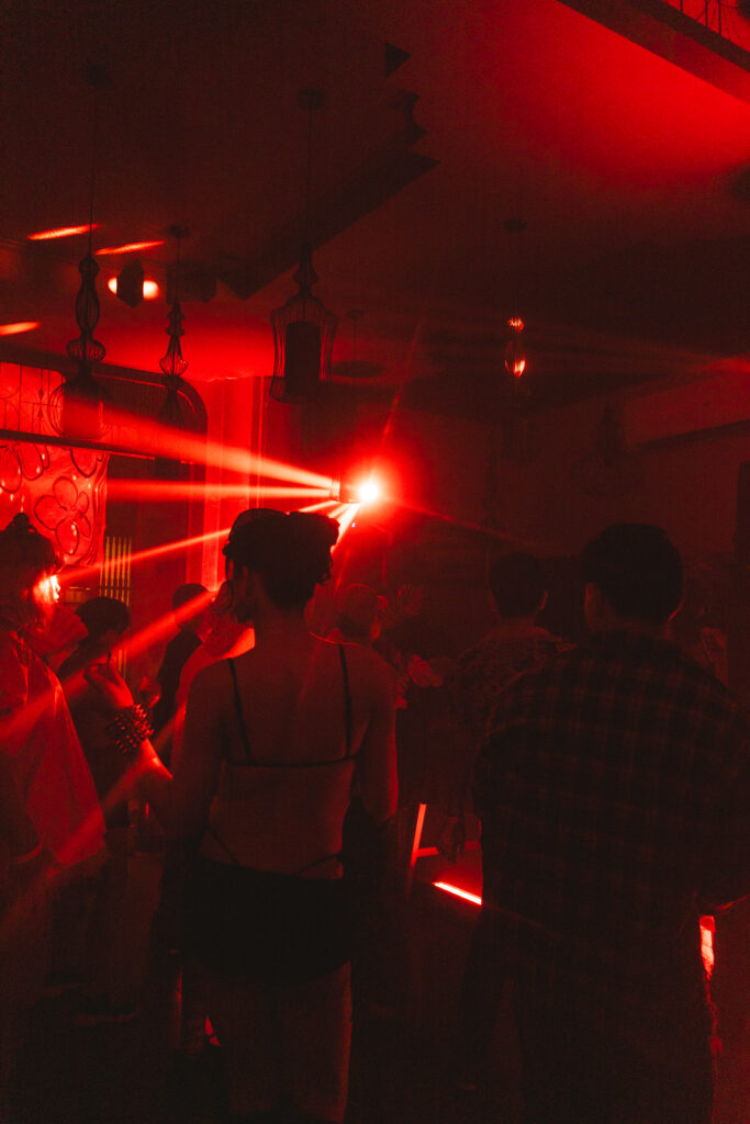 Crowd dancing under red lights at LAMANO during Mixed Temptations