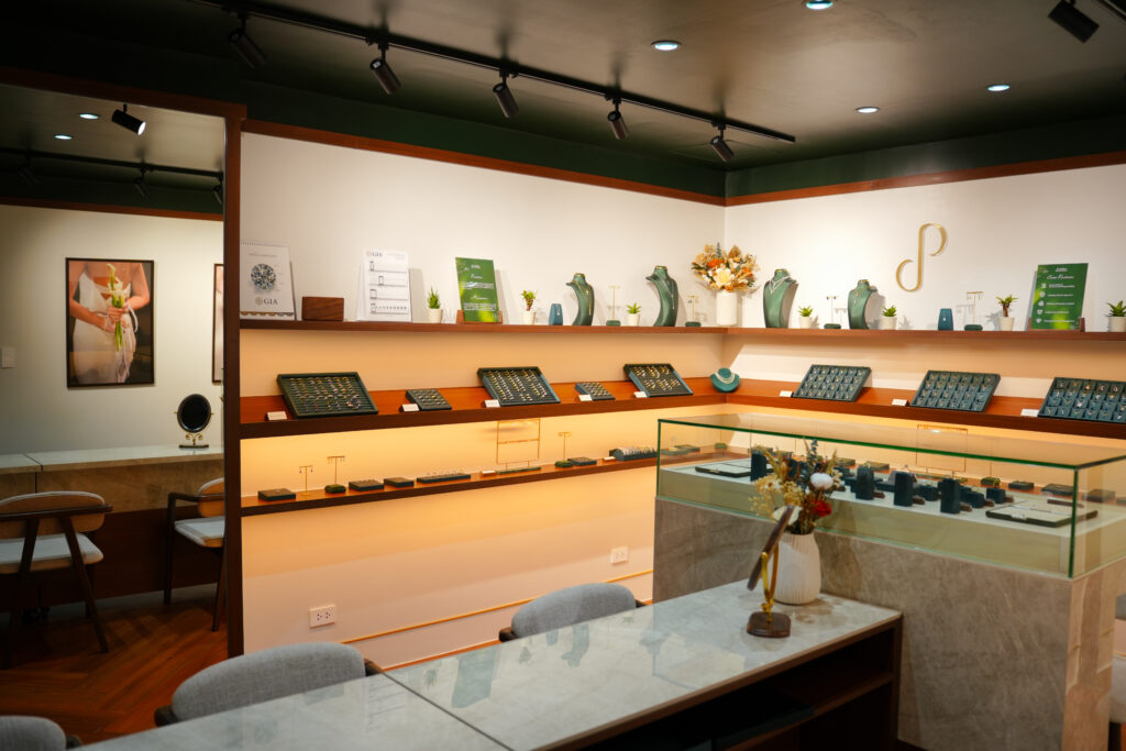 Warmly lit interior shelves of Pristine Paradigm showing sustainable lab grown jewelry trays