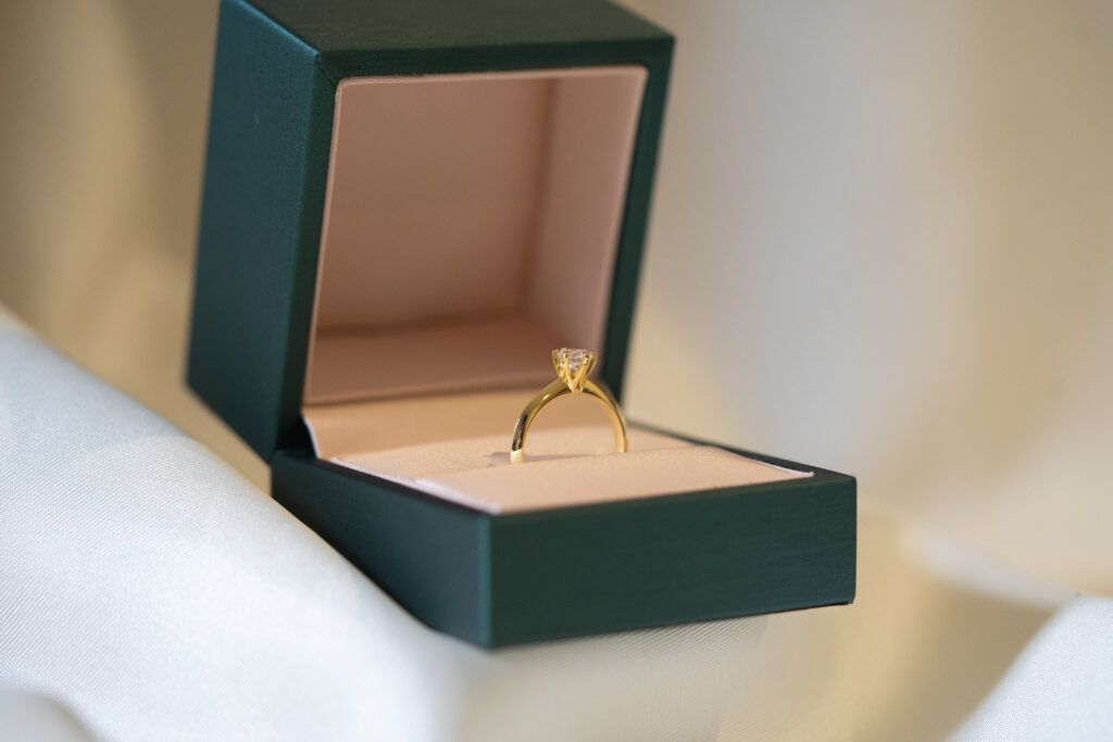 Selene Classic Solitaire Ring displayed inside a dark green velvet Pristine Paradigm box