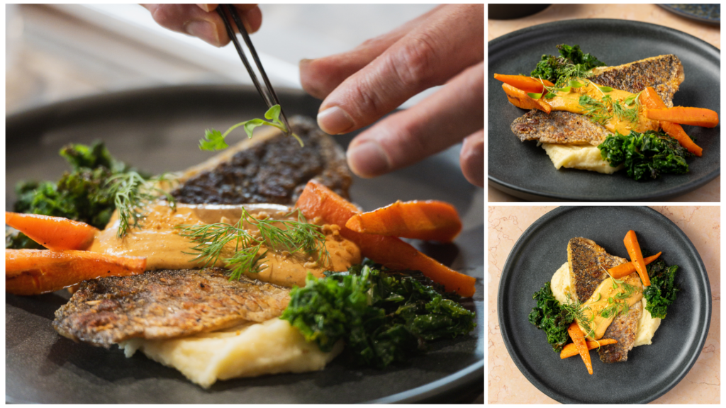 Chef plating Roasted Seabass with herb sauce, charred carrots, and kale